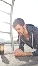 Young determined man training alone on street sports ground in sunny day